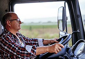 Fatigued Truck Driver Behind The Wheel of Tractor Trailer
