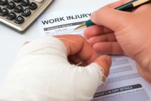 Workers Compensation Lawyer helps workplace injury victim file paperwork.