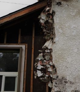 Asbestos showing in a damage wall. Asbestos Lawyers in Georgia