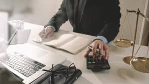 Lawyer using calculator to compute compensation for brain injury cases.