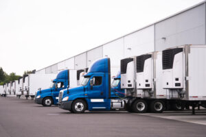 Blue delivery trucks on parking