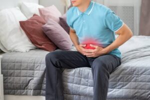 Man with abdominal pain suffering at home,