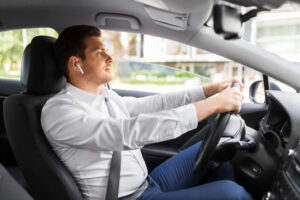 Driver using blue tooth headset to answer the phone while driving.