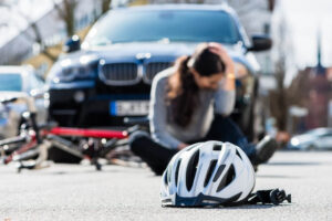 Lady cyclist suffering injuries from accident.