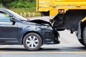 Rear-end collision of car and yellow truck in the highway