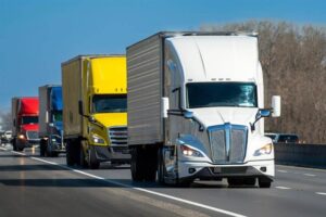 Commercial trucks passing in the interstate highway.