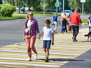 Mother and son crossing the pedestrian lane.